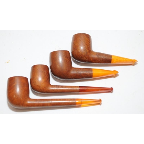 251 - Collection of vintage briar pipes with amber mouthpieces, includes a silver collar example and a num... 