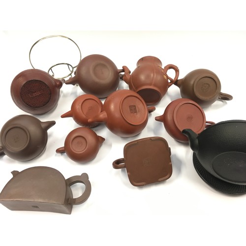 67 - Collection of oriental terracotta teapots (12).