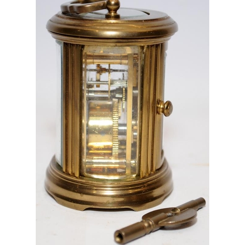 370 - Quality Matthew Norman miniature oval carriage clock with key. Seen working. All bevelled glass pane... 