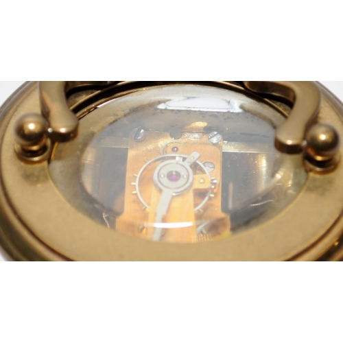 370 - Quality Matthew Norman miniature oval carriage clock with key. Seen working. All bevelled glass pane... 