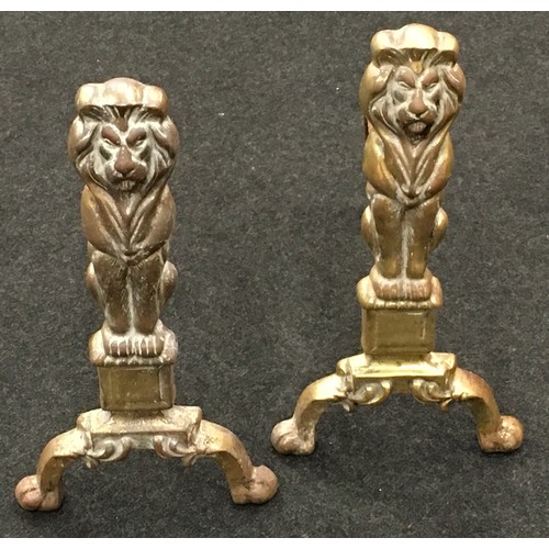 287 - Pair of vintage cast iron fire dogs depicting brass lions each 45cm tall.