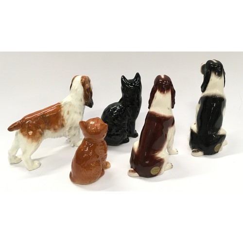 73 - Two Beswick cats together with two Beswick dogs and another by Royal Doulton (5).