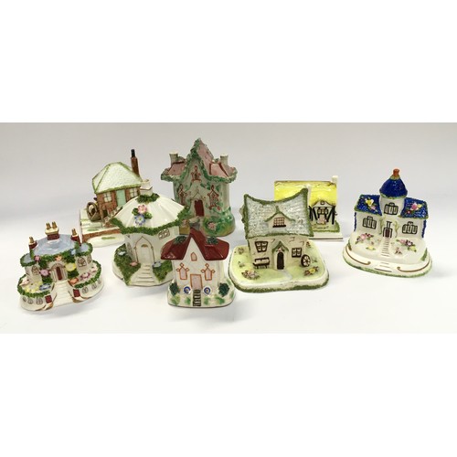 76 - Collection of Coalport and other porcelain cottages (8).