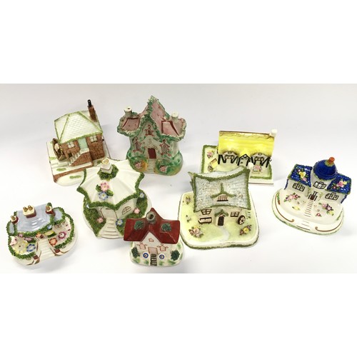 76 - Collection of Coalport and other porcelain cottages (8).