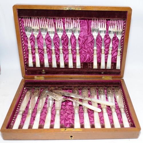 95 - Two complete canteens of cutlery in hinged wooden cases to include a fish set with faux MOP handles ... 