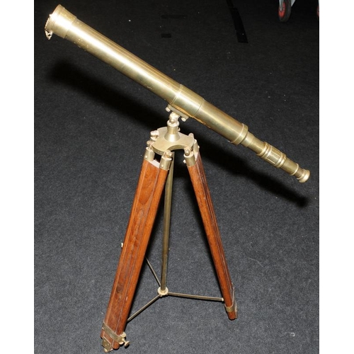 286 - Large brass telescope on adjustable brass and wood tripod base. O/all length of telescope 73cms