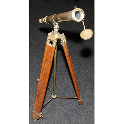 286 - Large brass telescope on adjustable brass and wood tripod base. O/all length of telescope 73cms