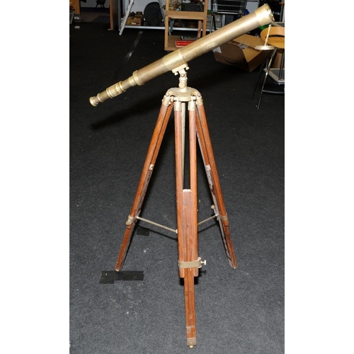 286 - Large brass telescope on adjustable brass and wood tripod base. O/all length of telescope 73cms