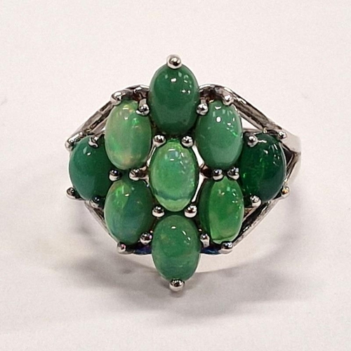 328 - 925 Silver ring of 9 green stones in diamond shape.