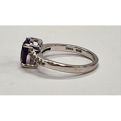 316 - 925 silver ring with central purple stone and CZ shoulders. Size P.