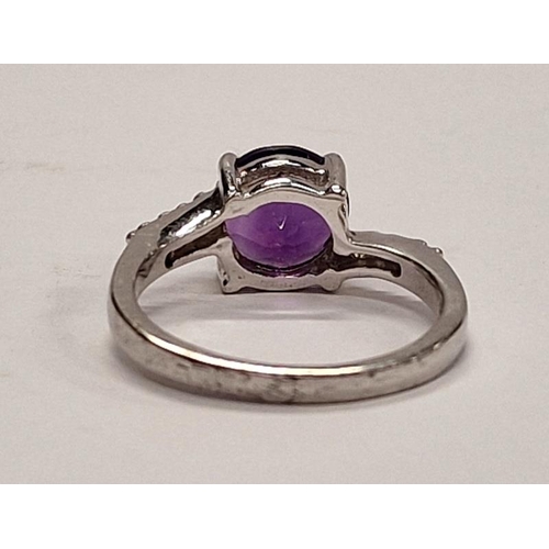 316 - 925 silver ring with central purple stone and CZ shoulders. Size P.