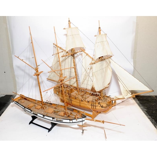 24 - Two large twin masted model sailing ships with sails and rigging on display stands. Length of larges... 