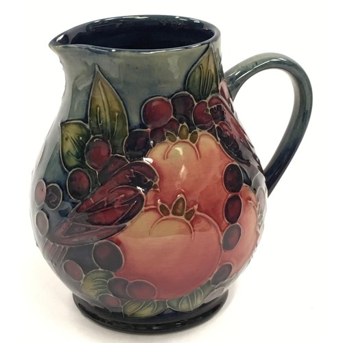 10 - Moorcroft Finches & Fruit pattern jug of slightly bulbous form. 14.5cm tall. Signed and stamped to b... 