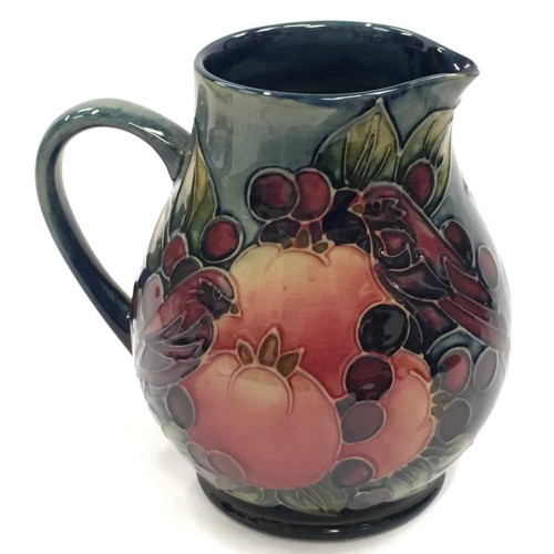 10 - Moorcroft Finches & Fruit pattern jug of slightly bulbous form. 14.5cm tall. Signed and stamped to b... 