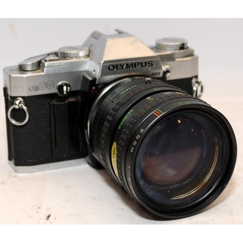 155 - Two vintage 35mm SLR cameras, an Exacta RTL with fitted Soligor 1:2.8 28mm lens, and an Olympus OM30... 