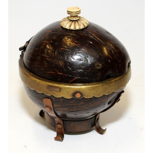 138 - A coconut shell box with bone finial and brass and copper mounts.