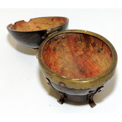 138 - A coconut shell box with bone finial and brass and copper mounts.