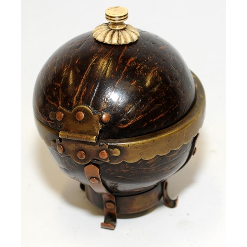 138 - A coconut shell box with bone finial and brass and copper mounts.