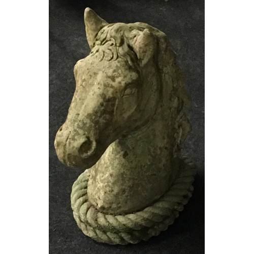 140 - Garden statuary: A reconstituted concrete horse's head. 48cms tall