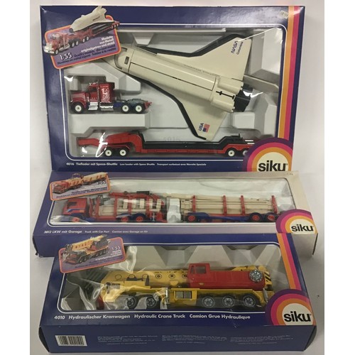 9 - Siku boxed group to include 4016 Low Loader with Space Shuttle, 3812 Truck with Car Port and 4010 Hy... 