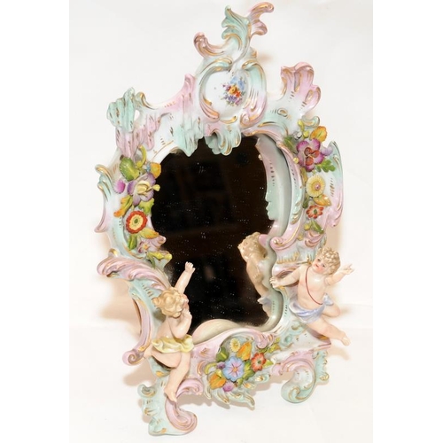 270 - A decorative Sitzendorf easel mirror featuring flowers and cherubs. 30cms tall