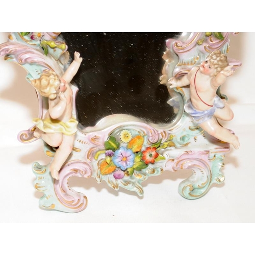 270 - A decorative Sitzendorf easel mirror featuring flowers and cherubs. 30cms tall