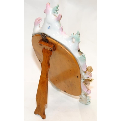 270 - A decorative Sitzendorf easel mirror featuring flowers and cherubs. 30cms tall