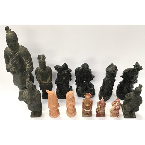 301 - A collection of oriental figurines to include terracotta warrior figures and carved stone examples (... 