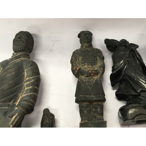 301 - A collection of oriental figurines to include terracotta warrior figures and carved stone examples (... 