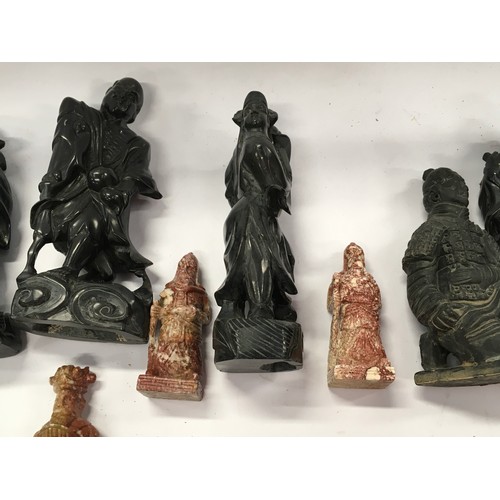 301 - A collection of oriental figurines to include terracotta warrior figures and carved stone examples (... 