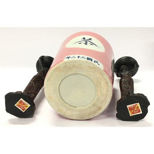 315 - Oriental pink earthenware spice jar together with a pair of contemporary African figures.