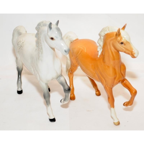 292 - Pair of Beswick prancing horses, a Palomino and a Grey, 18cms tall