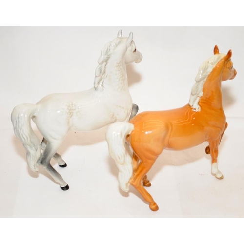 292 - Pair of Beswick prancing horses, a Palomino and a Grey, 18cms tall