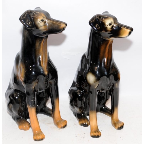 320 - Pair of large glazed ceramic seated dogs, one a/f. Approx 40cms tall