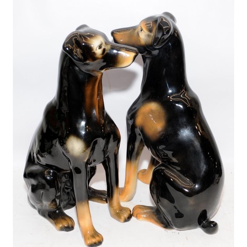 320 - Pair of large glazed ceramic seated dogs, one a/f. Approx 40cms tall