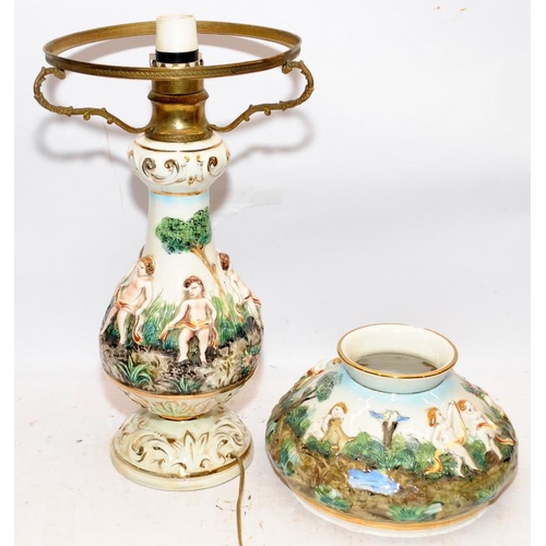 324 - A vintage Capo di Monte ceramic lamp base with applied cherubs and foliage a/f. O/all height 52cms.