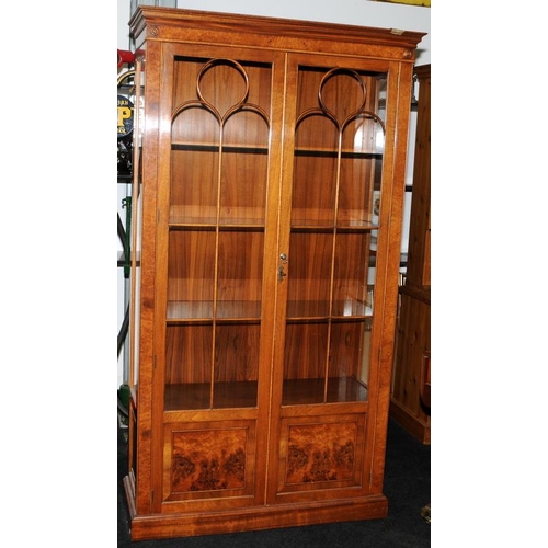 4 - Tall walnut veneer glazed two door display unit with interior lighting. Glazed panels to front and b... 