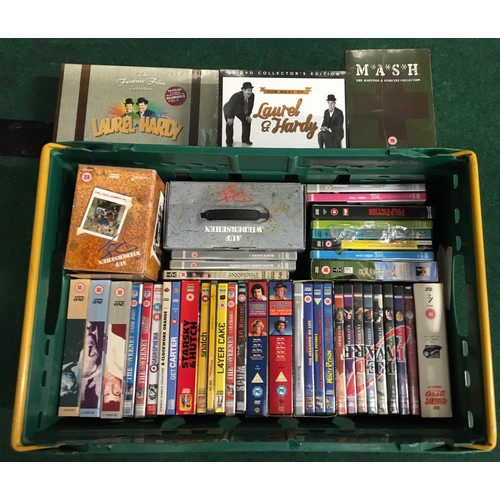 219 - A crate contains various dvd/box sets to include Mash, laurel and hardy, Auf Wiedershen.