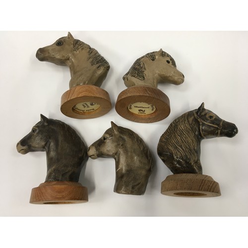 123 - Poole Pottery Stoneware set of four horseheads each on wooden bases, together with one other loose (... 