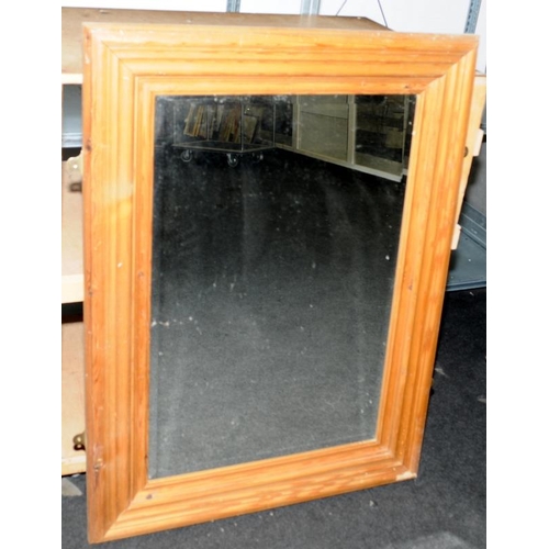 172 - Substantial bevelled edge mirror in a pine frame. O/all size 84cms x 112cms