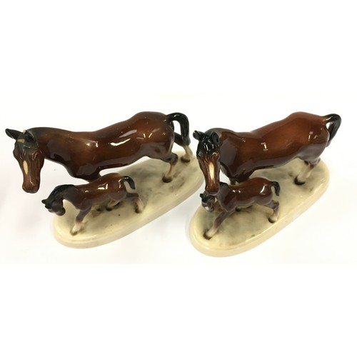 35 - A pair of ceramic horse and foal figurines with marks to bases each measuring 19cm tall.