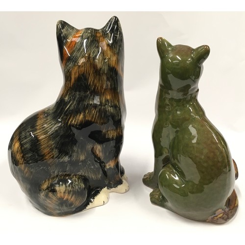 59 - Two ceramic cat figurines the largest measuring 31cm.