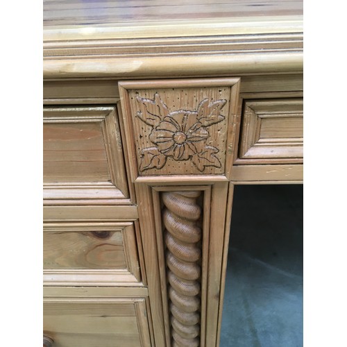 458 - Solid pine desk with 3 side draws and a central draw turned up supports and carved motif decoration ... 