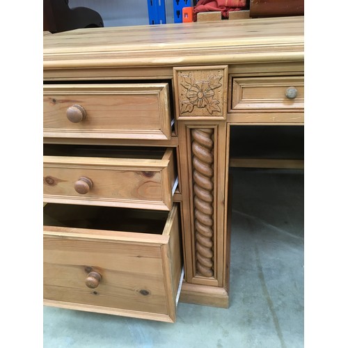 458 - Solid pine desk with 3 side draws and a central draw turned up supports and carved motif decoration ... 