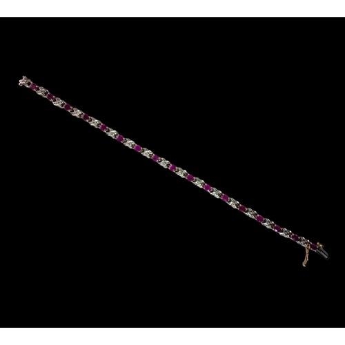 439 - A 9ct Gold Diamond & Ruby Line Bracelet. H/M to box clasp. Approx 0.85ct Diamond 7g. 7 inches in len... 