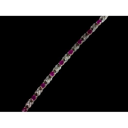 439 - A 9ct Gold Diamond & Ruby Line Bracelet. H/M to box clasp. Approx 0.85ct Diamond 7g. 7 inches in len... 