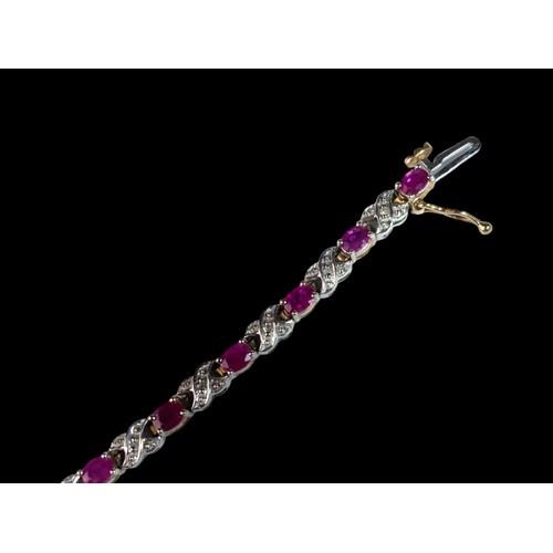 439 - A 9ct Gold Diamond & Ruby Line Bracelet. H/M to box clasp. Approx 0.85ct Diamond 7g. 7 inches in len... 