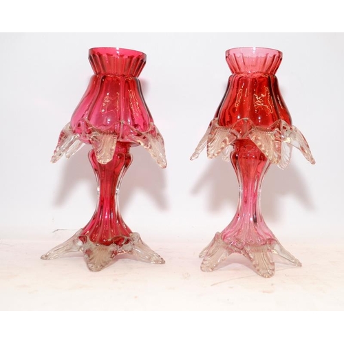 181 - Pair of antique ruby glass candlesticks. 18.5cms tall