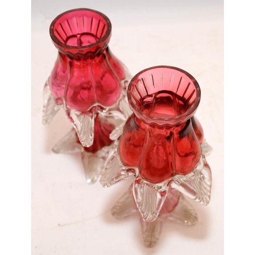 181 - Pair of antique ruby glass candlesticks. 18.5cms tall