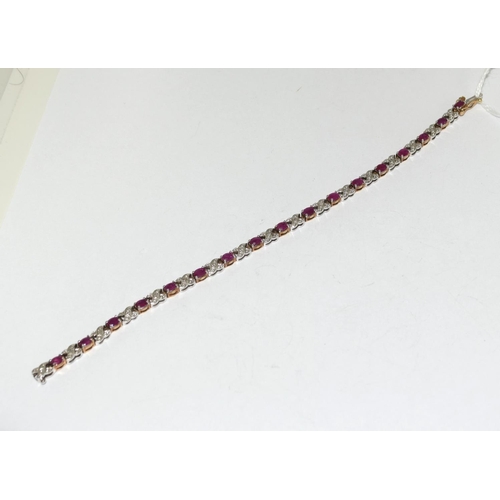 439 - A 9ct Gold Diamond & Ruby Line Bracelet. H/M to box clasp. Approx 0.85ct Diamond 7g. 7 inches in len... 